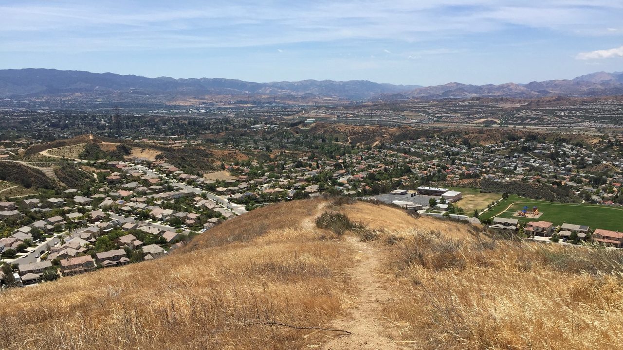 Santa Clarita Valley neighborhoods and mountains from a hilltop trail, California